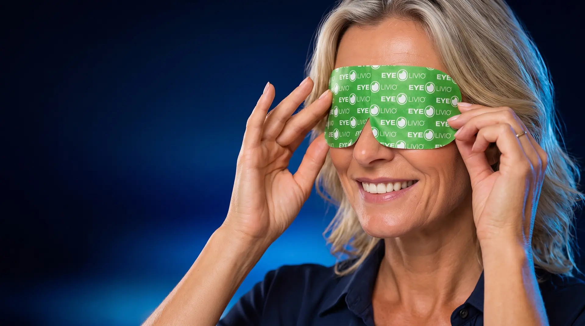 Smiling woman holding an EYELIVIO self-warming mask over her eyes